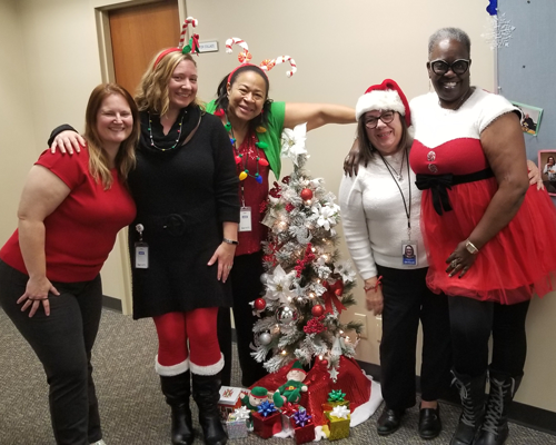 CyraCom Cherry Hill employees in holiday outfits