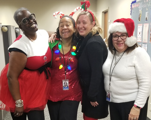 CyraCom employees smiling in holiday outfits