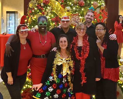 CyraCom Cherry Hill employees in holiday outfits