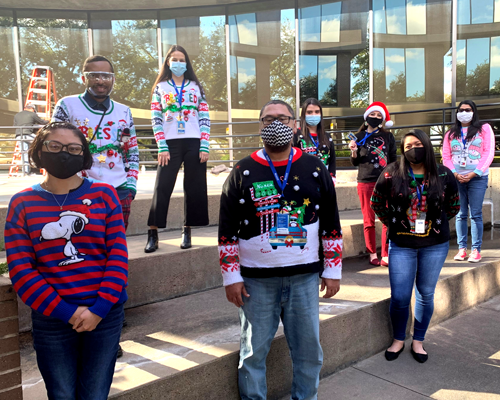 CyraCom Houston Center employees in holiday sweaters